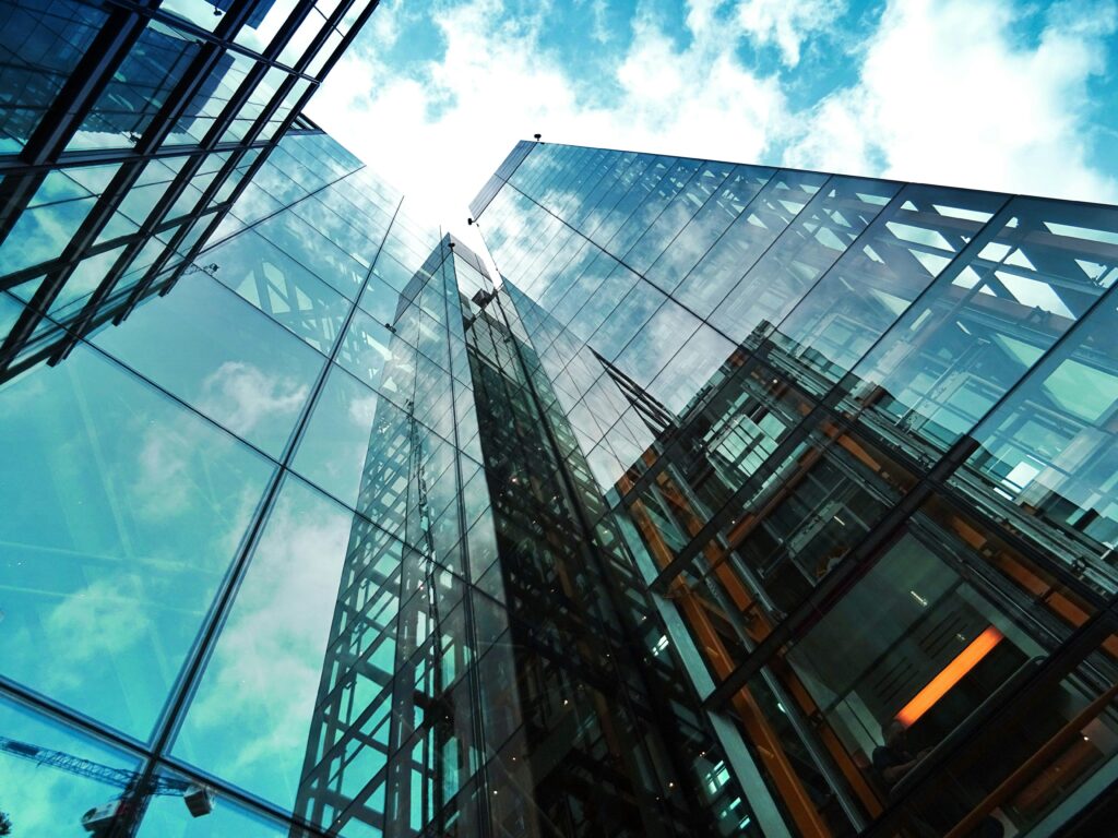 pexels photo 443383 443383 A striking view of a modern glass skyscraper reflecting the sky and clouds.